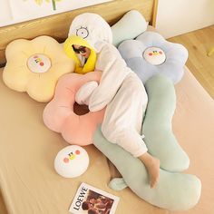 a bed with pillows and stuffed animals on it in the shape of people sleeping together