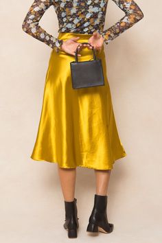 Say hello to the Tiff Skirt in Chartreuse - the perfect combination of style and comfort! This midi-length skirt made from yellow satin fabric is not only elegant but also easy to slip on. And with its stretchy material, you'll never want to take it off. A must-have for any fashion-forward wardrobe. Satin Skirt For Evening In Fall, Satin Skirt For Fall Evening, Chic Satin Skirt For Fall, Chic Yellow Evening Skirt, Fall Evening Satin Skirt, Fall Silk Midi Skirt, Silk Midi Skirt For Fall, Silk Flowy Skirt For Fall, Yellow Evening Skirt For Spring