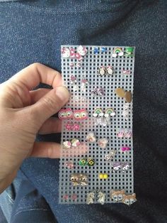 a person holding onto a piece of plastic with lots of small buttons on it's side