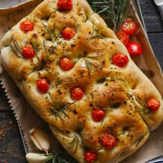 garlic bread with tomatoes and rosemary on top