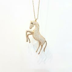 - Horse decorated with zirconia stones pendant necklace is made with high quality 14K real solid gold. - High polish finish and the horse pendant necklace for women decoreted with white and black diamond cut zirconia stones . - This cute, charm, dainty, delicate, elegant, trendy women jewelry horse pendant necklace has been artfully designed for timeless yet modern millennial fashion. - You receive the necklace in a beautiful and free gift box - Free shipping (Arrive within 4 business days to th Elegant Formal Necklace With Horse Design, Gold Horse Design Pendant Necklace, Elegant Horse Design Pendant Jewelry, Elegant Horse Design Necklace As Gift, Elegant Necklace With Horse Design As A Gift, Gold Pendant Necklace With Horse Design, Elegant Gold Jewelry With Horse Design, Horse Design Pendant Necklace As Gift, Elegant Yellow Gold Jewelry With Horse Design