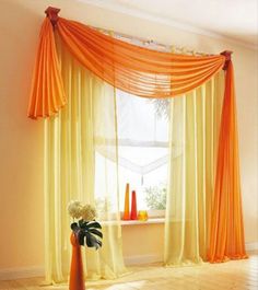 a living room curtain design with orange drapes on the windowsill and an orange potted plant next to it