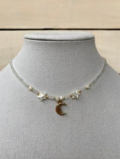 this gorgeous celestial necklace is perfect for anyone who loves the moon. White Moon Phase Celestial Necklace, White Celestial Moon Phase Necklace, White Celestial Necklace With Moon Phase, Bohemian White Moon Necklace, Handmade White Celestial Necklace, White Star-shaped Jewelry With Moon Charm, Bohemian White Necklace With Moon Charm, Celestial Style Round Beads For Jewelry Making, White Celestial Necklace With Moon Charm