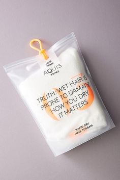 a packaged package with an orange and white design on the front that says truth wet hair is prone to damage how you dry it matters