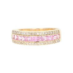 This ring has 11 Natural Pink Sapphires that weigh 0.87 carats and 40 Natural Round Cut Diamonds that weigh 0.30 carats (Clarity: SI, Color: F) The total carat weight of the band is 1.17 carats. The band is made in 14 Karat Yellow Gold and weighs approximately 3.3 grams. The ring is a size 7 and can be re-sized, if need, free of charge. Pink Wedding Band, Pink Diamond Band, Pink Sapphire Diamond Ring, Pink Wedding Rings, Sapphire And Diamond Band, Yellow Engagement Rings, E 40, Modern Ring, Diamonds And Gold