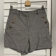 Add A Touch Of Nautical Elegance To Your Wardrobe With These Stylish Double-Breasted Sailor Shorts. The Houndstooth Pattern Adds A Classic Touch, While The High Waist And Button Accents Create A Flattering Silhouette. Perfect For Both Casual Outings And Formal Occasions, These Shorts Are Suitable For Travel, Parties, Or Cocktails. Chic Fitted Plaid Shorts, Chic Plaid Short Bottoms, Chic Plaid Short-length Bottoms, Chic Gingham Shorts, Chic Short Plaid Bottoms, Trendy Summer Bottoms With Houndstooth Pattern, Trendy Houndstooth Pattern Bottoms For Summer, Trendy Houndstooth Summer Bottoms, Chic Gingham Shorts For Day Out