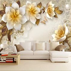 a living room with white furniture and large flowers on the wall behind it is a couch