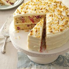 a cake with white frosting and sprinkles is cut from the plate