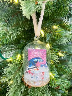 an ornament hanging from a christmas tree with the name campari on it