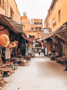 an outdoor market with people shopping in it