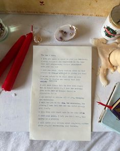 an old letter sitting on top of a table next to some other items and candles