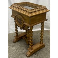 an old wooden table with a clock on it's side and some wood legs