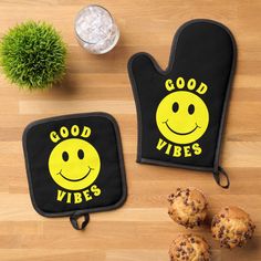 two oven mitts that say good vibes and one has a smiley face on it