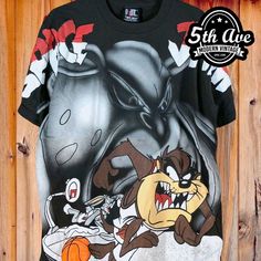 #spacejam #looneytunes #cartoon #cartoontee #tee #tshirt #streetwear #vintagereprint #y2k #shopvintage #thrift #thriftshop #90sstyle #vintageclothing #vintaget #bootleg #alloverprint #aop Graphic Tee With Character Print And Crew Neck, Vintage Cotton T-shirt With All Over Print, Black Retro T-shirt With Graffiti Print, Fan Merchandise Graphic Tee With Character Print, Graphic Tee With Character Print For Fan Merchandise, Vintage Black Top For Fan Conventions, Vintage Black Tops For Fan Conventions, Black Vintage Tops For Fan Conventions, Pop Culture Sublimation Crew Neck T-shirt With Graphic Print