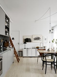 an image of a kitchen with white walls and wood flooring in the middle, on instagram