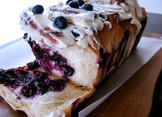 a piece of cake with blueberries and cream on it