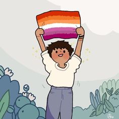 a person holding up a rainbow colored cake in the air with other people around him