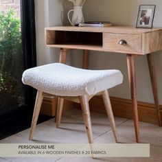 a wooden desk with a white foot stool