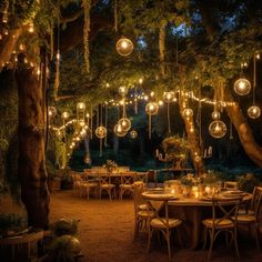 an outdoor dining area with lights strung from the trees and hanging decorations on the ceiling