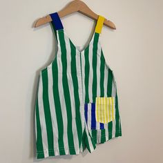 Green and white striped shortalls with blue and yellow straps & back pockets. Appliqué of three blonde white children with text “Fun Stuff!” on front. Good vintage condition with some expected wear. Size 3 (19” length). Fun Texts, Blue And Yellow, Age 3, Green And White, Fun Stuff, Vintage House, White Stripe, Blonde, Yellow