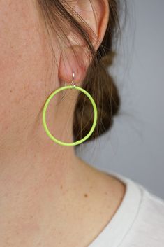 These lightweight circle earrings are sure to become your new favorite pair. An update on classic hoops, each circle retains evidence of their making - a small dot marks the spot where I hand-weld each earring. Approximately 1 3/4" tall (including ear wires) and 1 3/8" wide. Powder coated in a neon yellow green color. Sterling silver ear wires. Handcrafted in my Pennsylvania studio. Ships in 1-2 business days. Comes in a gift box. Treat yourself or a loved one! Green Hoop Earrings With Ear Wire, Everyday Green Circular Earrings, Plant Jewelry, Ring Bracelet Chain, Grey Home Decor, Radiant Orchid, Chain Extenders, Painted Books, Azure Blue