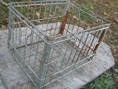 a metal cage sitting on top of a cement slab