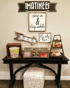 a black table topped with lots of different items and pictures on it's wall