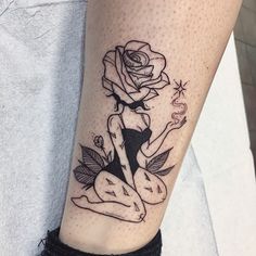 a woman with a rose tattoo on her leg