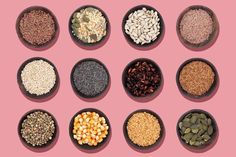 nine bowls filled with different types of seeds and nuts on a pink background, top view