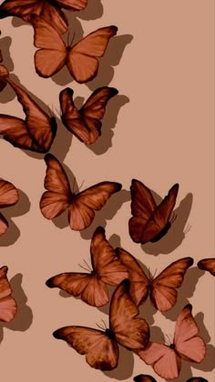 a group of orange butterflies flying in the air