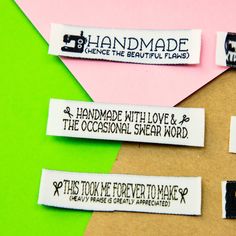 three different types of handmade labels on a piece of brown paper with black and white lettering