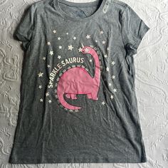 New With Tags Large 10 -12 Gray T Shirt With Pink Dinosaur, Glitter Letters And Stars Great For The Summer Or Hot Weather Bundle And Save I Ship Next Day Except On Weekends. Pink Dinosaur Print Short Sleeve Top, Pink Dinosaur Print Crew Neck Top, Pink Crew Neck Top With Dinosaur Print, Boys Basketball Shorts, Dino Shirt, Dinosaur Outfit, Pink Dinosaur, Casual Activewear, Girls Art