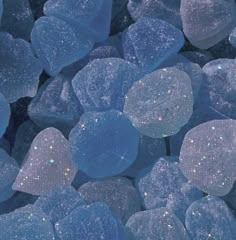 some blue and white rocks with sparkles in the middle one is surrounded by smaller ones