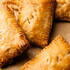 several pastries are arranged on a piece of parchment paper