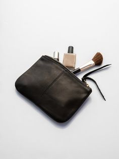 simple leather makeup bag with stitched center seam and leather zipper pull. measures 7.5" x 5". made in california. erica tanov Leather Bag Making, Mirror Boots, Erica Tanov, Denim Rug, Sewing Details, Leather Wallet Pattern, Leather Makeup Bag, Handmade Leather Bracelets, Corporate Gifting