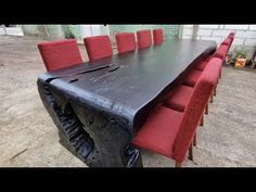 a large table with red chairs around it