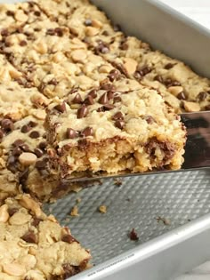 a close up of a pan of food with chocolate chip cookies and oatmeal bars