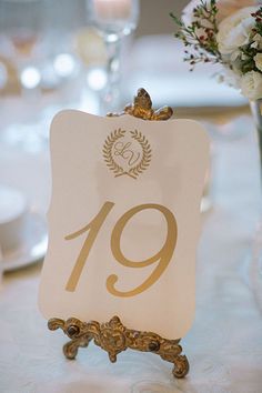 the table number is displayed on an ornate stand