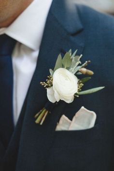 a man in a suit with a boutonniere on his lapel