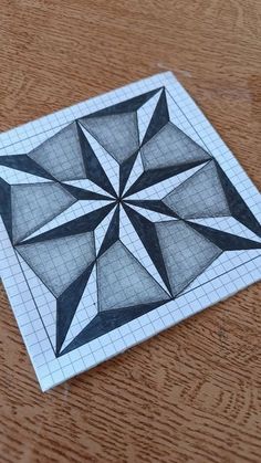 a piece of paper with a black and white drawing of a star design on it