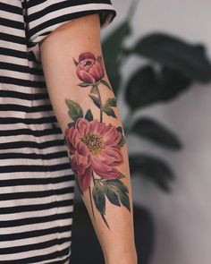 a woman with a flower tattoo on her arm