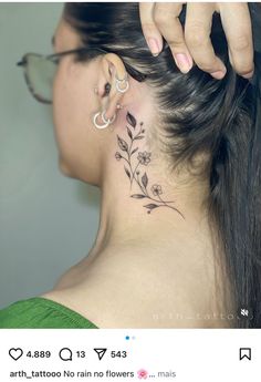 a woman with a flower tattoo on her neck