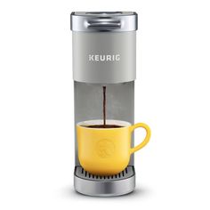 keurig single serve coffee maker with yellow mug and stainless steel trimmings