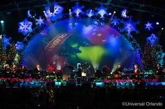 the stage is lit up with christmas lights and decorations on it, as well as snowflakes