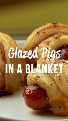 glazed pigs in a blanket on a white plate with text overlay that reads glazed pigs in a blanket