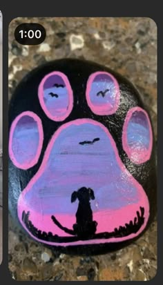 a painted rock with a dog's paw on it