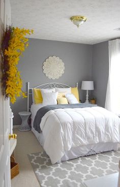 a bedroom with gray walls and yellow accents