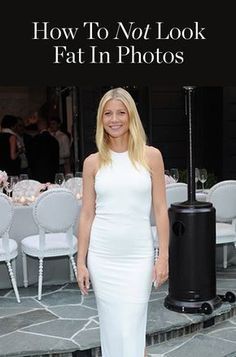 a woman in a white dress posing for the camera