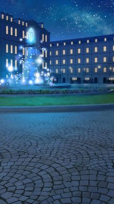 a large building lit up at night with stars in the sky