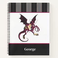 a spiral notebook with an image of a dragon on it's cover and the words george written in black